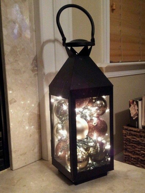 Christmas Ornament Lantern. Just put ball ornaments and a string of battery operated christmas lights in a lantern, now you have this stunning and unique lantern to light up your way during this holiday nignt!